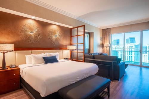 a bedroom with a large bed and a large window at No Resort Fee Strip View Balcony+Free Valet+ Pool in Las Vegas