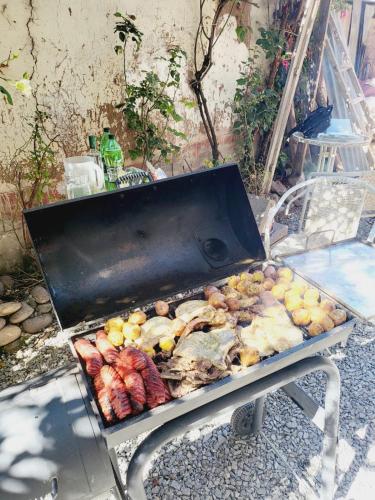 a grill with many different types of food on it at Casa Conquista in Cusco