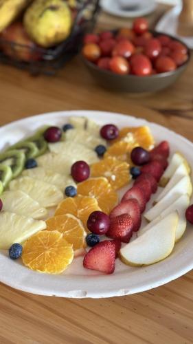 a white plate with fruit on a table at Casa Septem in Villa Seca