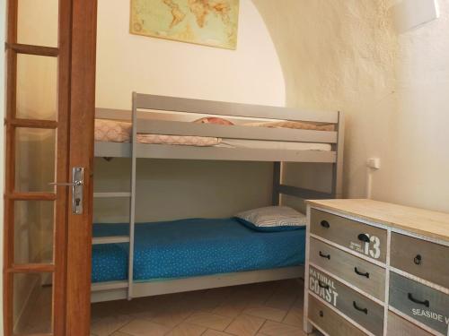a bedroom with two bunk beds and a desk at Magnifiques voûtes avec SPA in Saint-Amant-Tallende