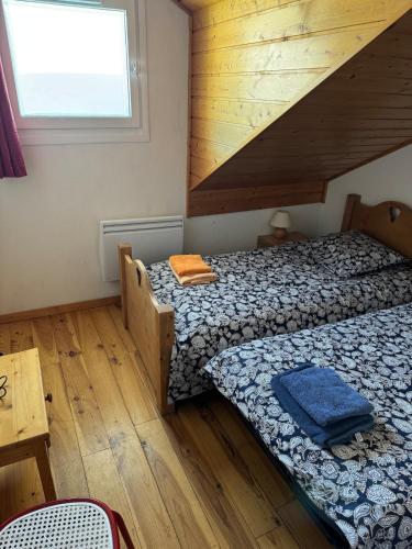 une chambre avec deux lits et une fenêtre dans l'établissement Rare Ski Apartment Chalet Flaine, à Arâches-la-Frasse
