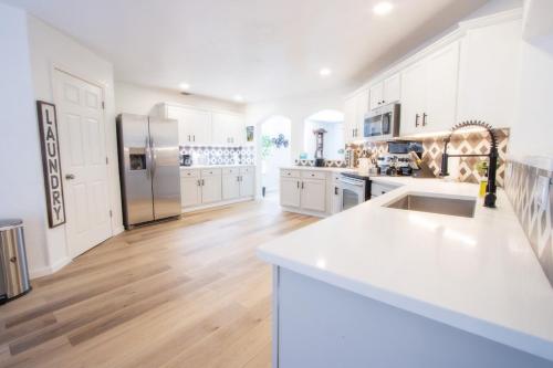 a kitchen with white cabinets and a white counter top at Big Family House w Theater Pool table in San Antonio