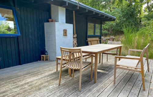a wooden table and chairs on a deck at 4 Bedroom Beautiful Home In Vejby in Vejby