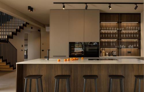 a kitchen with a island with bar stools at Stunning Home In Kastelir With Sauna in Kaštelir