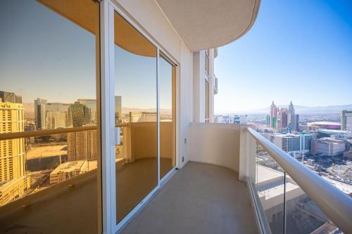 an apartment balcony with a view of the city at No Resort Fee Strip View Balcony+ Free Valet+Pool in Las Vegas