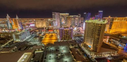 a view of a city at night with at No Resort Fee Strip View Balcony+ Free Valet+Pool in Las Vegas