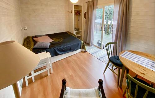 a small room with a bed and a table at 2 Bedroom Cozy Home In Uddevalla in Uddevalla