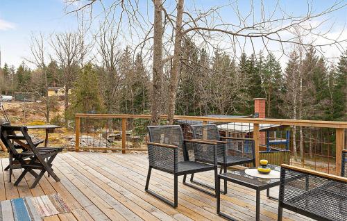 a patio with chairs and a table on a deck at 2 Bedroom Cozy Home In Uddevalla in Uddevalla