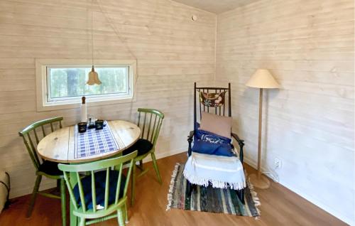 a room with a table and chairs and a lamp at 2 Bedroom Cozy Home In Uddevalla in Uddevalla