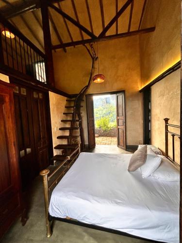 a bedroom with a bed and a staircase at Cabañas en la montaña Viga Vieja in San Peregrino