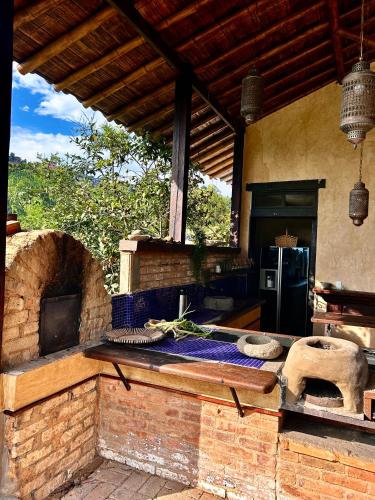 an outdoor kitchen with an oven and a counter at Cabañas en la montaña Viga Vieja in San Peregrino