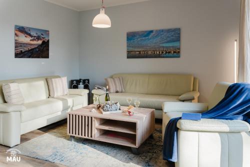 a living room with two couches and a coffee table at Ferienbauernhof Mau in Fehmarn