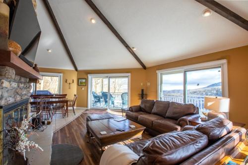 a living room with a couch and a fireplace at Oates Point of View in Seven Devils