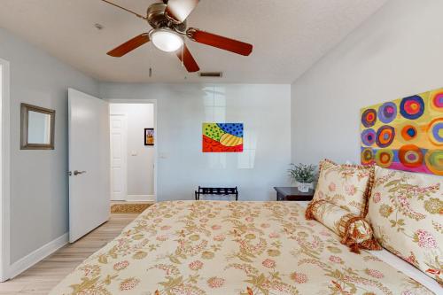 a bedroom with a bed and a ceiling fan at Sunset Cove in Melbourne
