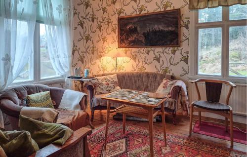 a living room with a couch and a table at 2 Bedroom Gorgeous Home In Åsensbruk in Åsensbruk