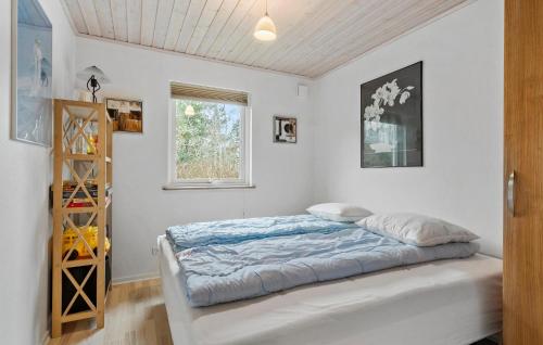 a bedroom with a bed and a window at Amazing Home In Højslev With Sauna in Højslev