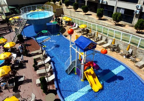 a pool with a slide and a water park at Cassino All Inclusive Resort Poços de Caldas By Nacional Inn in Poços de Caldas