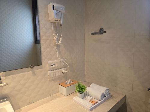 a bathroom with a shower with a phone in it at Two Green Park in New Delhi