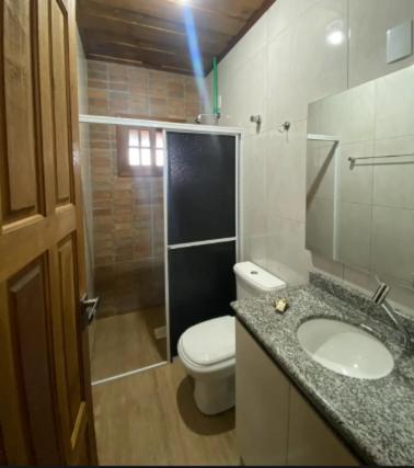 a bathroom with a toilet and a sink and a shower at Pousada Rural Encanto do Riacho in Bom Jardim da Serra
