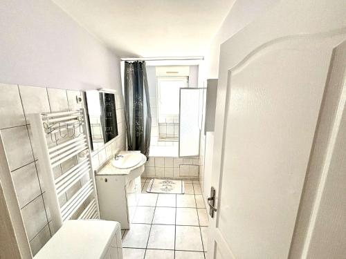 une salle de bain blanche avec un lavabo et des toilettes dans l'établissement Appartement 3 pièces Port la Nouvelle PN000-151, à Port-la-Nouvelle