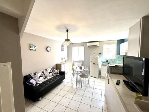 un salon avec un canapé et une cuisine dans l'établissement Appartement 3 pièces Port la Nouvelle PN000-151, à Port-la-Nouvelle