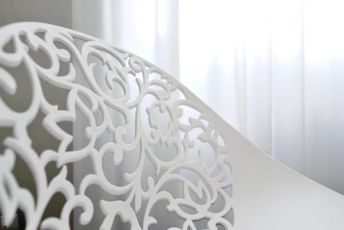 a white stair railing in front of a window at La Corte sul Naviglio in Boffalora sopra Ticino