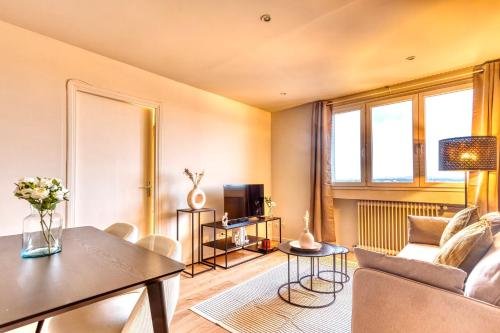 un salon avec un canapé et une table dans l'établissement Le Panoramique - Grand T2 métro B Oullins, à Oullins