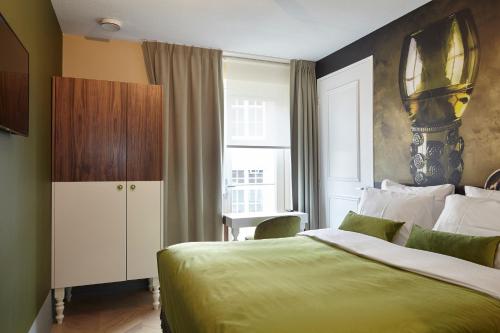 Ένα ή περισσότερα κρεβάτια σε δωμάτιο στο The Muse Amsterdam - Boutique Hotel
