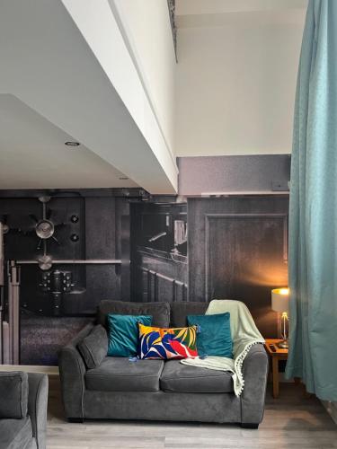 a living room with a couch with pillows on it at 5 Halifax House, apartment 3 in Liverpool