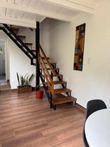 a room with a wooden staircase and a table at Casi en Casa 2 in Lincoln