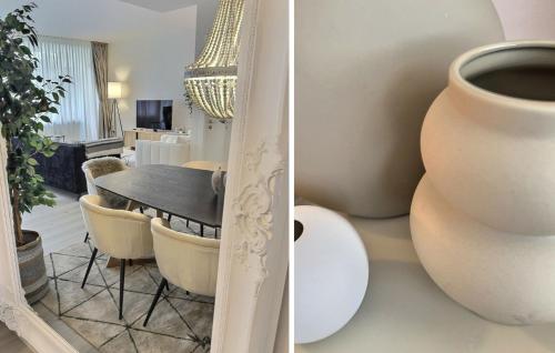 a dining room with a table and a vase at Experience luxury in this stunning three-bedroom modern townhouse frontline to the San Roque Golf in San Roque