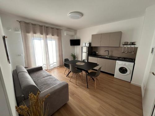 a living room with a couch and a table at Mediterranea Apartment in Trapani