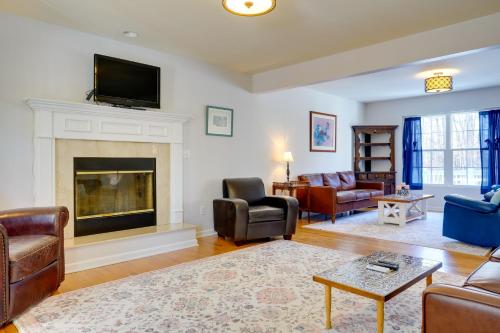 a living room with couches and a fireplace at Group Getaway about 15 Mi to Charlottesville! in Zion Crossroads