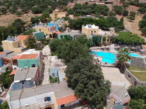 an aerial view of a resort with a swimming pool at Arolithos Traditional Village Hotel in Tílisos