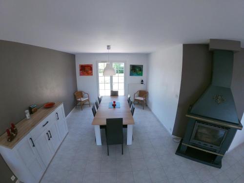 une cuisine avec une table en bois et une cheminée dans l'établissement Maison avec grand jardin, à Saint-Martial-sur-Né
