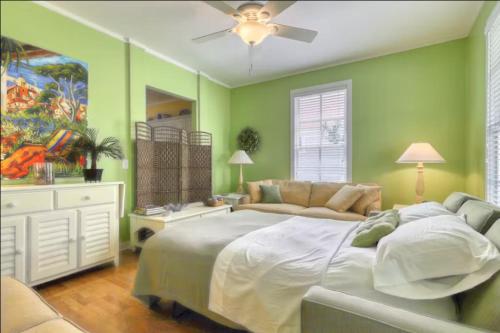 a bedroom with a large bed and a ceiling fan at Bay Breeze - 3 Min Walk to Beach in Tybee Island