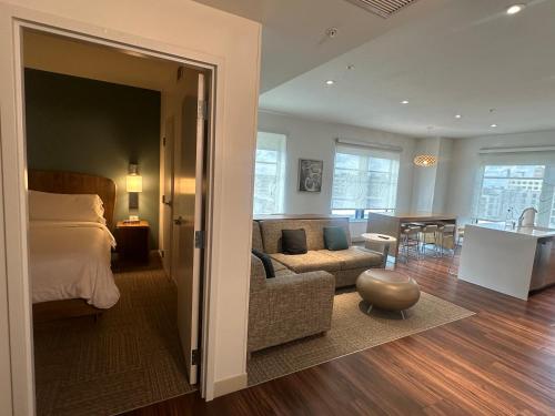 a bedroom with a bed and a living room with a couch at Element Minneapolis Downtown North Loop in Minneapolis