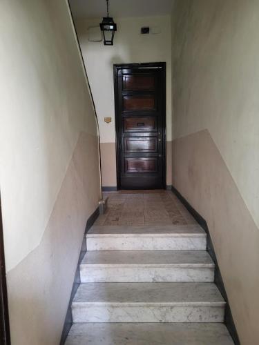 a stairway leading to a wooden door in a building at Flawer Flat x4 in Turin