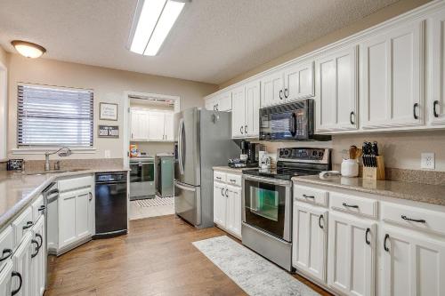 a kitchen with white cabinets and stainless steel appliances at Pool On The Golf Course With 3BR and Close to Tarleton in Stephenville