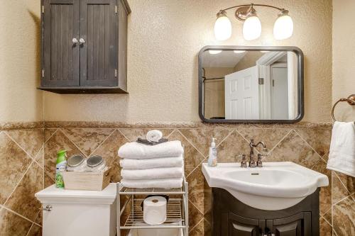 a bathroom with a sink and a mirror and a toilet at Pool On The Golf Course With 3BR and Close to Tarleton in Stephenville