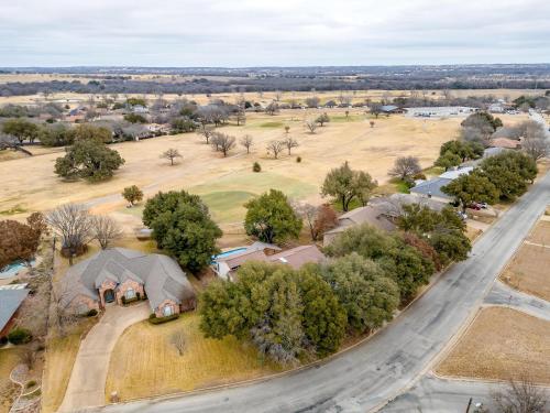 an aerial view of a house and a road at Pool On The Golf Course With 3BR and Close to Tarleton in Stephenville