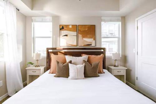 a bedroom with a large white bed with pillows at Amazing Water View with Jacuzzi & Sky Lounge in Sparks