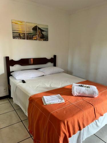 two beds sitting next to each other in a room at Pousada Encanto dos Anjos in Búzios