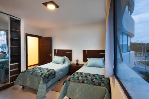 A bed or beds in a room at Mai Suites Apart Hotel