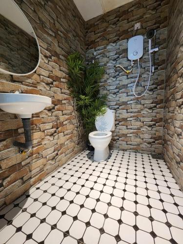 a bathroom with a toilet and a sink at Sun Rock Home by Ipoh Maju Stay in Ipoh