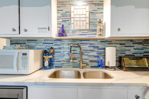 a kitchen with a sink and a microwave at Emerald Isle Vacation Rental, Walk to Beach! in Emerald Isle