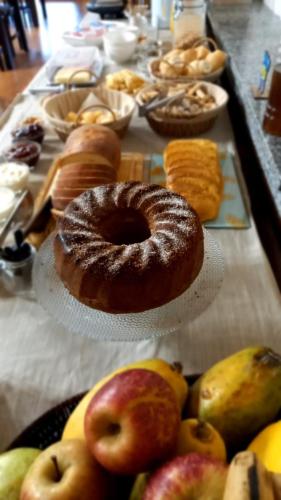 una tabella piena di diversi tipi di ciambelle di Pousada Rural Canto do Riacho a Bom Jardim da Serra