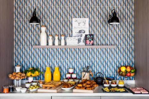 a buffet with bread and other foods on a table at Okko Hotels Cannes Centre in Cannes
