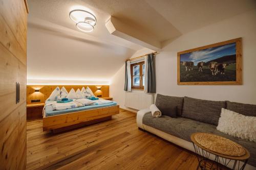 a living room with a couch and a bed at Bauernhof Unterbichl in Flachau