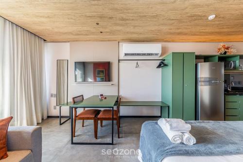 a living room with a table and a kitchen at NWTs - Estúdios em Prédio com Vista Mar in Maceió